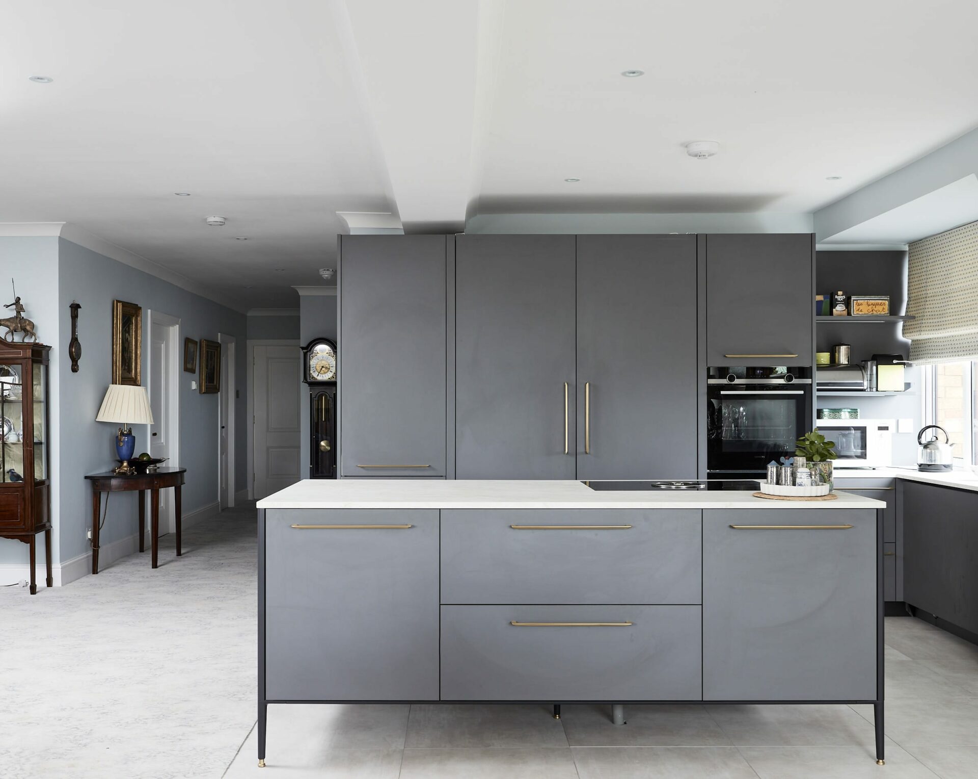 Interior design Dublin. The kitchen had to be installed in the centre of the living space to the kitchen was designed So that the entire working kitchen could be closed off when not in use.